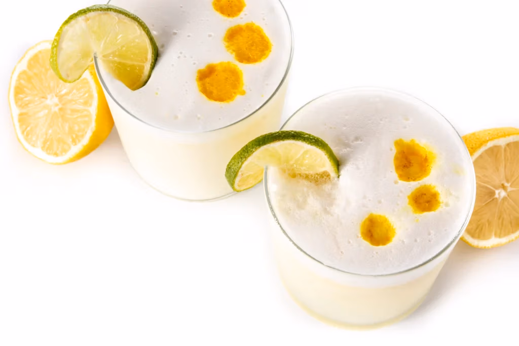 Pisco sour cocktail isolated white with traditional peruvian cocktail - JohnMartin's Pisco sour cocktail isolated white with traditional peruvian cocktail